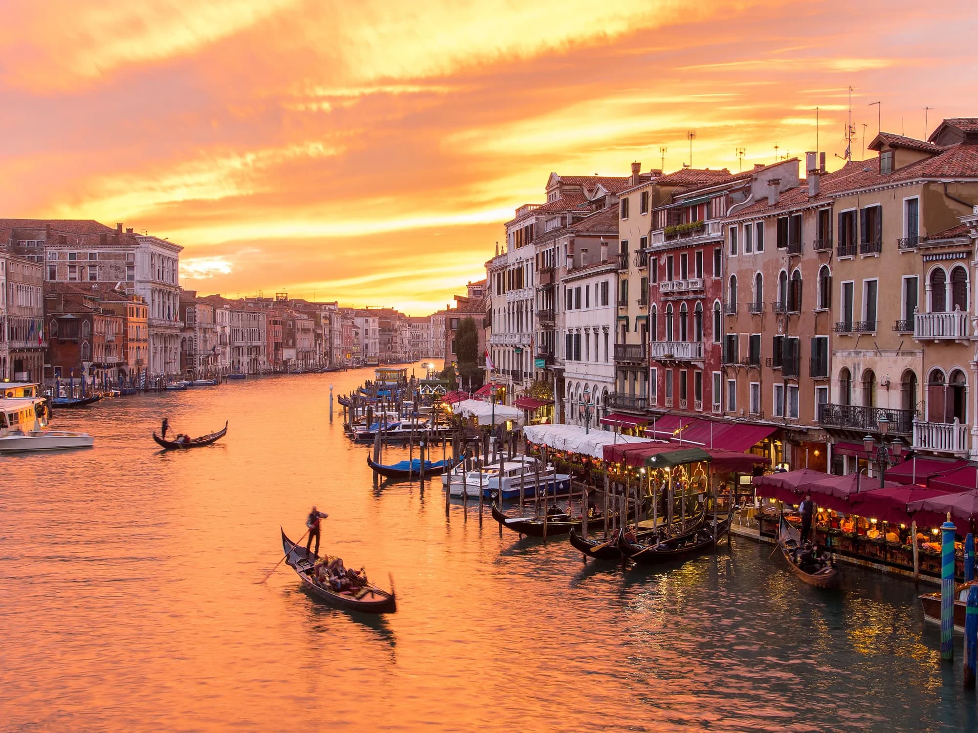 The Grand Canal in Venice at sunset, with gondolas on the water